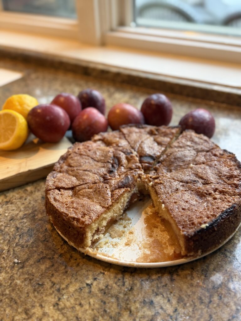 Gluten-free plum torte with fresh plums and lemon