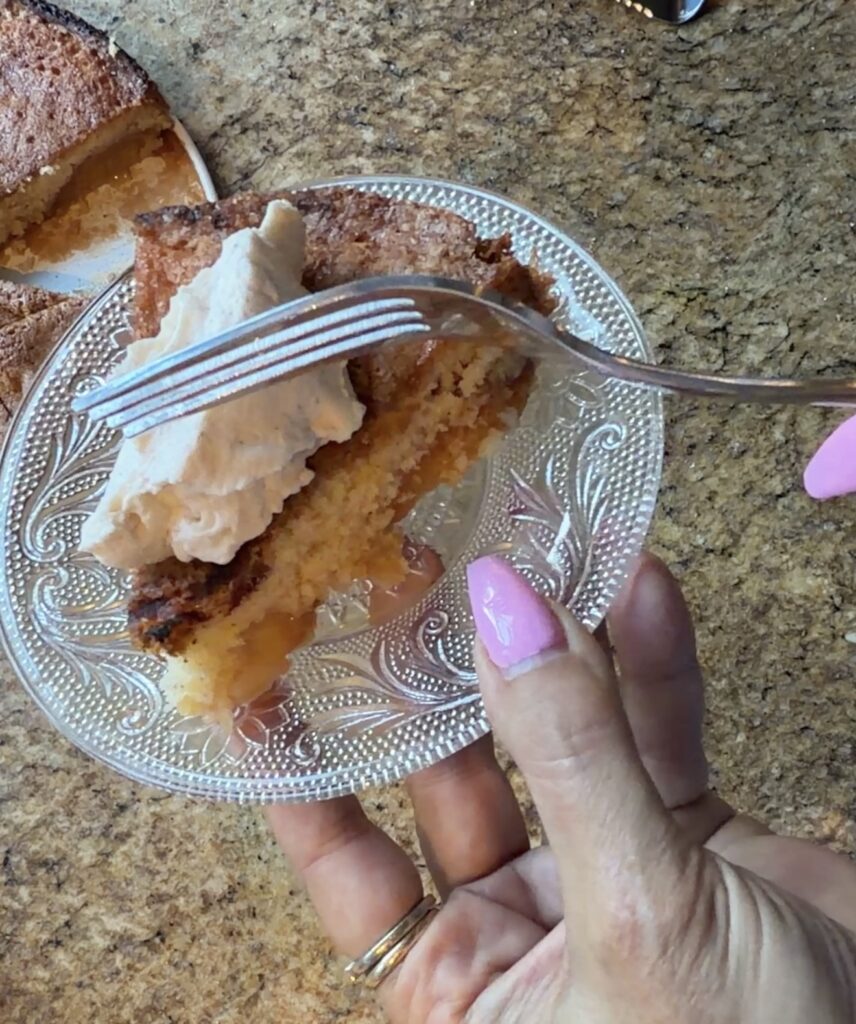 Slice of gluten-free plum torte with whipped cream