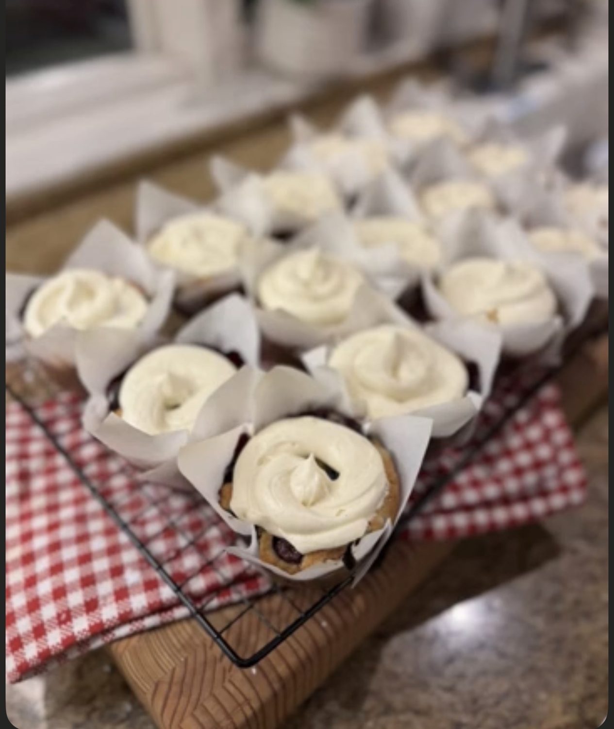 Gluten-free blueberry muffins topped with cream cheese frosting