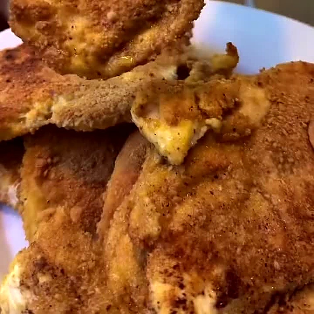 Crispy gluten-free chicken cutlets stacked on a plate