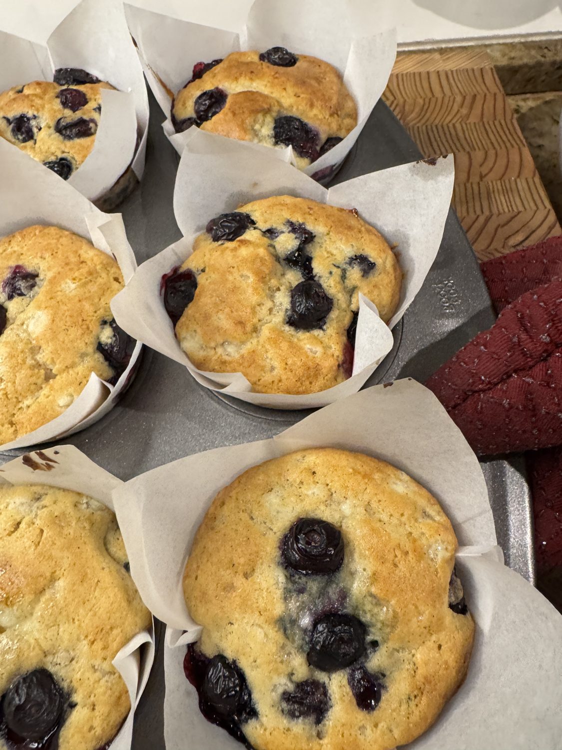 Close-up of golden gluten-free blueberry muffins bursting with blueberries